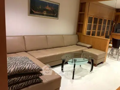 Spacious living room with elegant leather sofa and glass coffee table