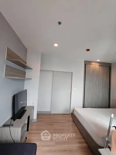 Modern bedroom with sleek design and wooden flooring