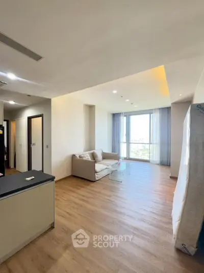 Spacious modern living room with wooden flooring and large windows