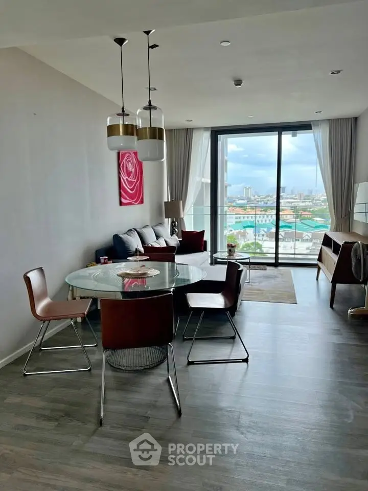 Modern living room with city view, stylish furniture, and elegant decor in a high-rise apartment.