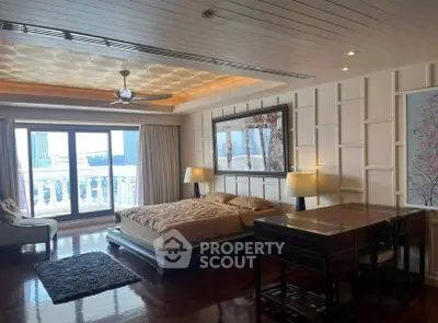 Luxurious bedroom with elegant decor and city view, featuring a stylish ceiling fan and large windows.