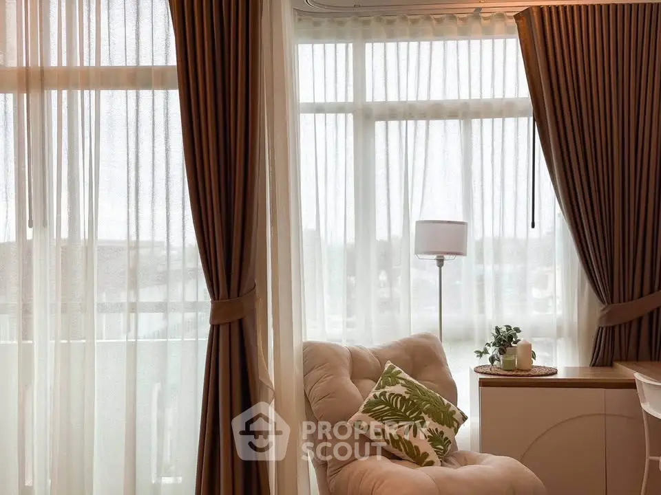 Cozy living room with elegant curtains and plush seating, perfect for relaxation.