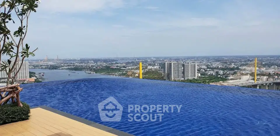 Stunning rooftop infinity pool with breathtaking cityscape and river views.