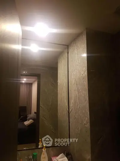 Luxurious bathroom with marble walls and modern lighting