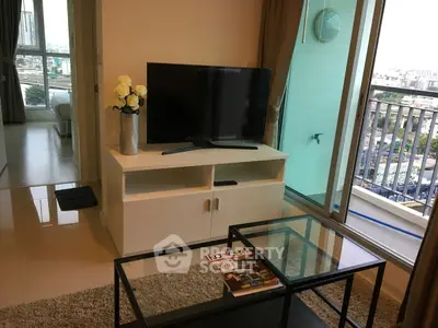 Modern living room with TV and balcony view in high-rise apartment