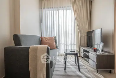 Modern living room with stylish sofa, TV, and elegant curtains