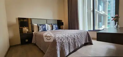 Luxurious bedroom with elegant decor and large windows in modern apartment