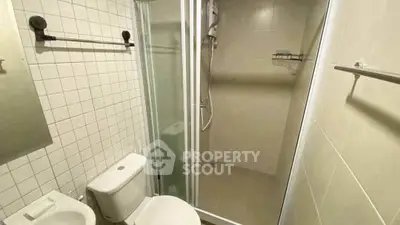 Compact bathroom with shower and modern fixtures in a real estate property.