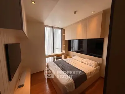 Modern bedroom with sleek design and natural light, featuring built-in storage and cozy ambiance.