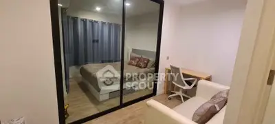 Cozy bedroom with glass partition and study area, featuring modern decor and comfortable furnishings.