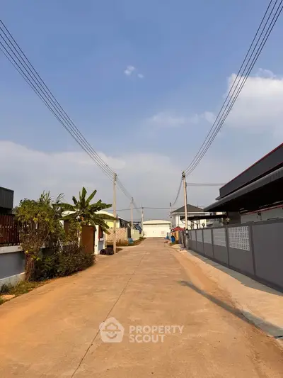 Charming suburban street with modern homes and clear blue sky, perfect for peaceful living.