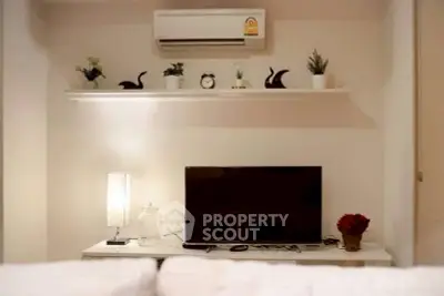 Modern living room with sleek TV setup and stylish decor accents.