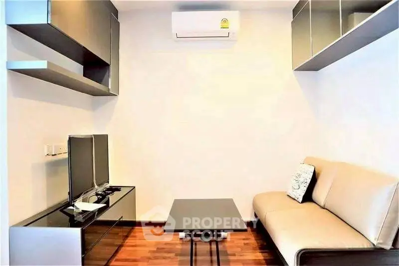 Modern living room with sleek furniture and air conditioning, perfect for urban living.