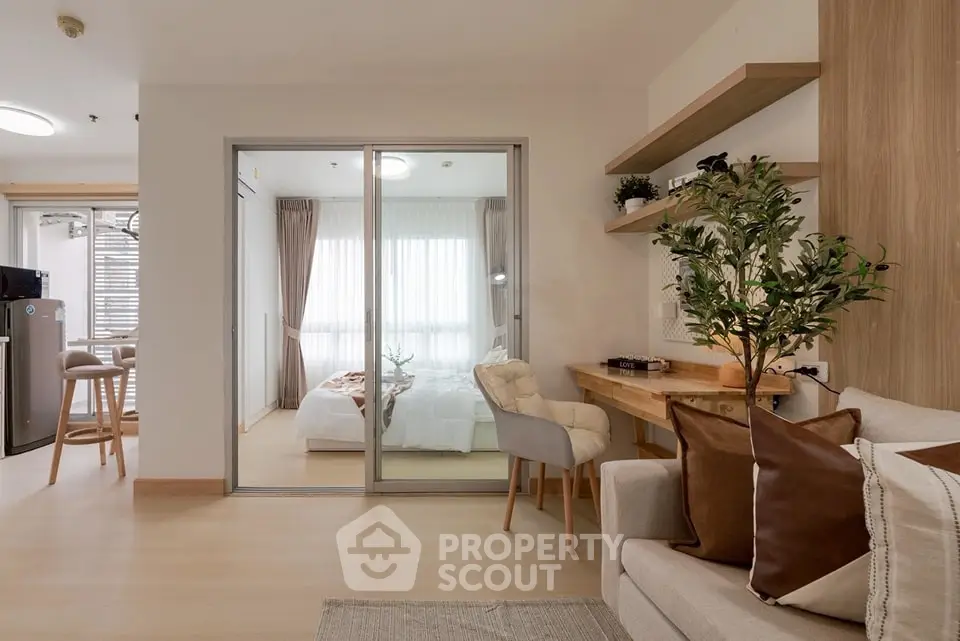 Modern open-plan living room with cozy bedroom view and stylish decor