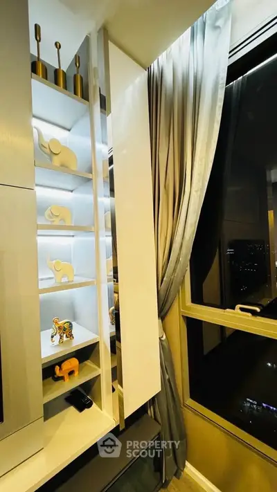 Stylish modern living room with elegant decor and night city view.