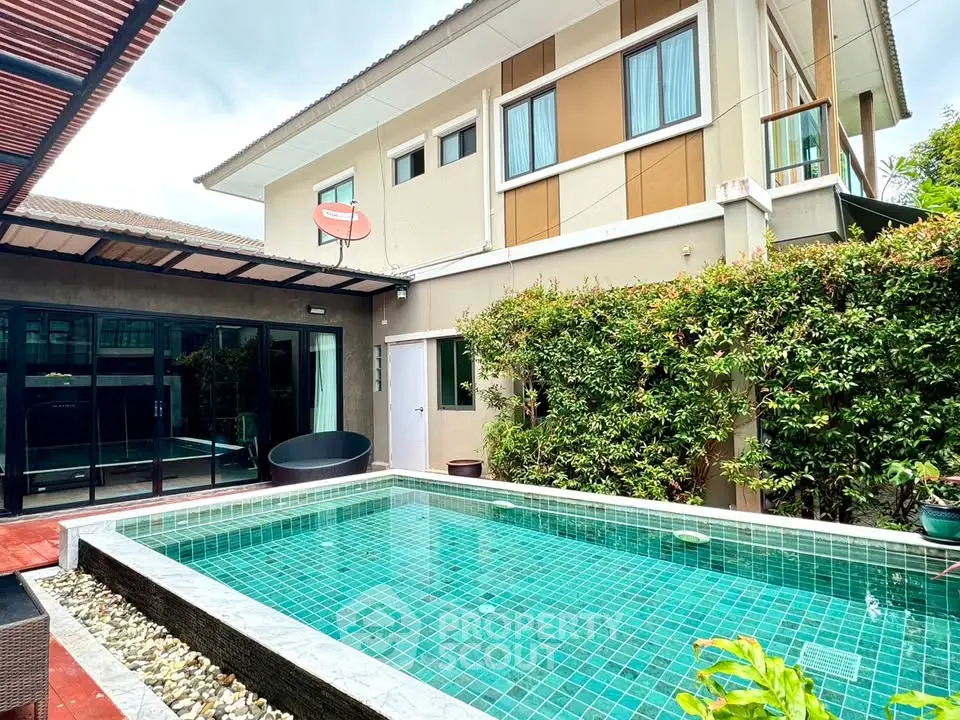 Modern home with private pool and lush greenery, perfect for luxury living.
