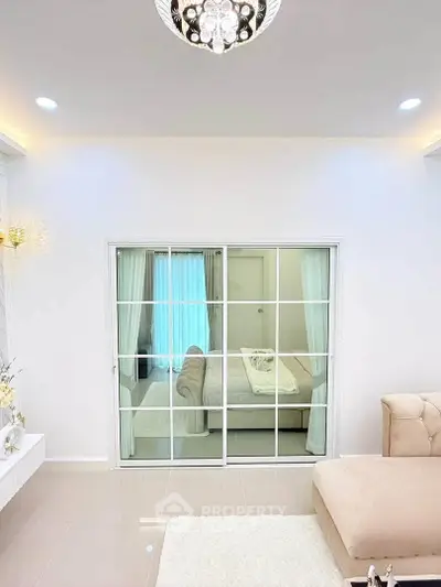 Elegant living room with modern decor and large sliding glass doors