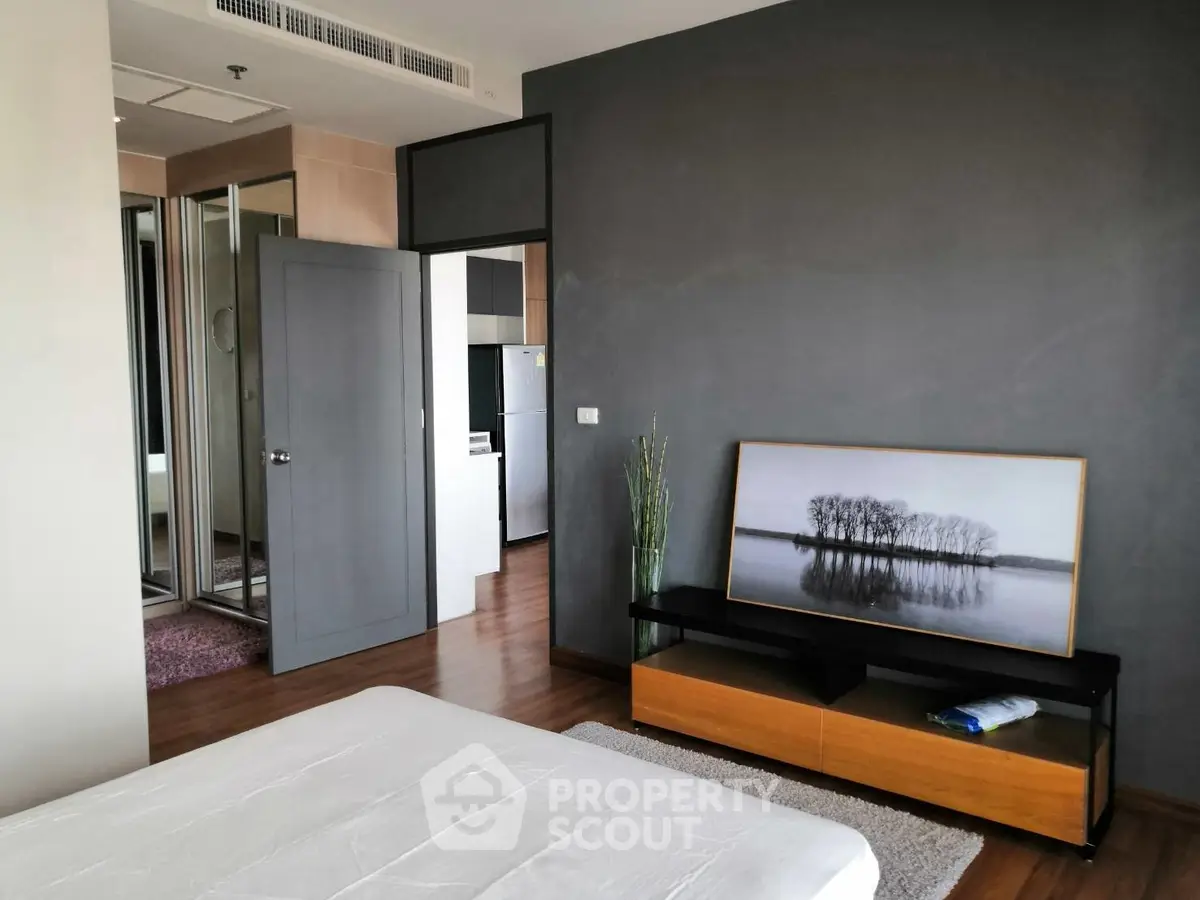 Modern bedroom with stylish decor and wooden flooring