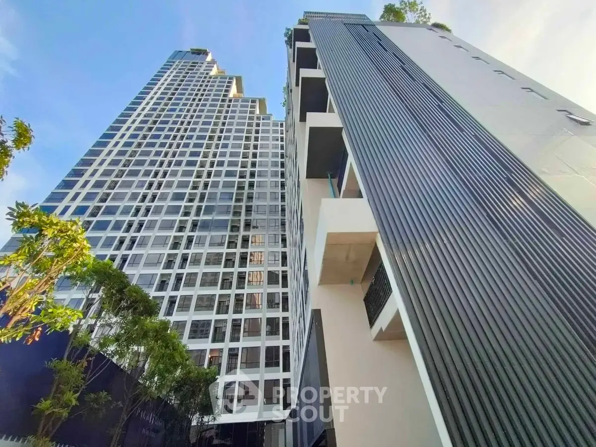Stunning modern high-rise buildings with sleek architecture and lush greenery, perfect for urban living.