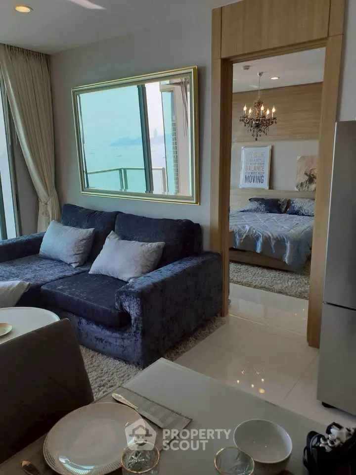 Luxurious living room with plush sofa and elegant bedroom view, perfect for modern living.