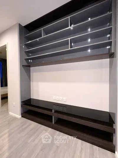 Modern built-in shelving unit with sleek design in a contemporary apartment interior.
