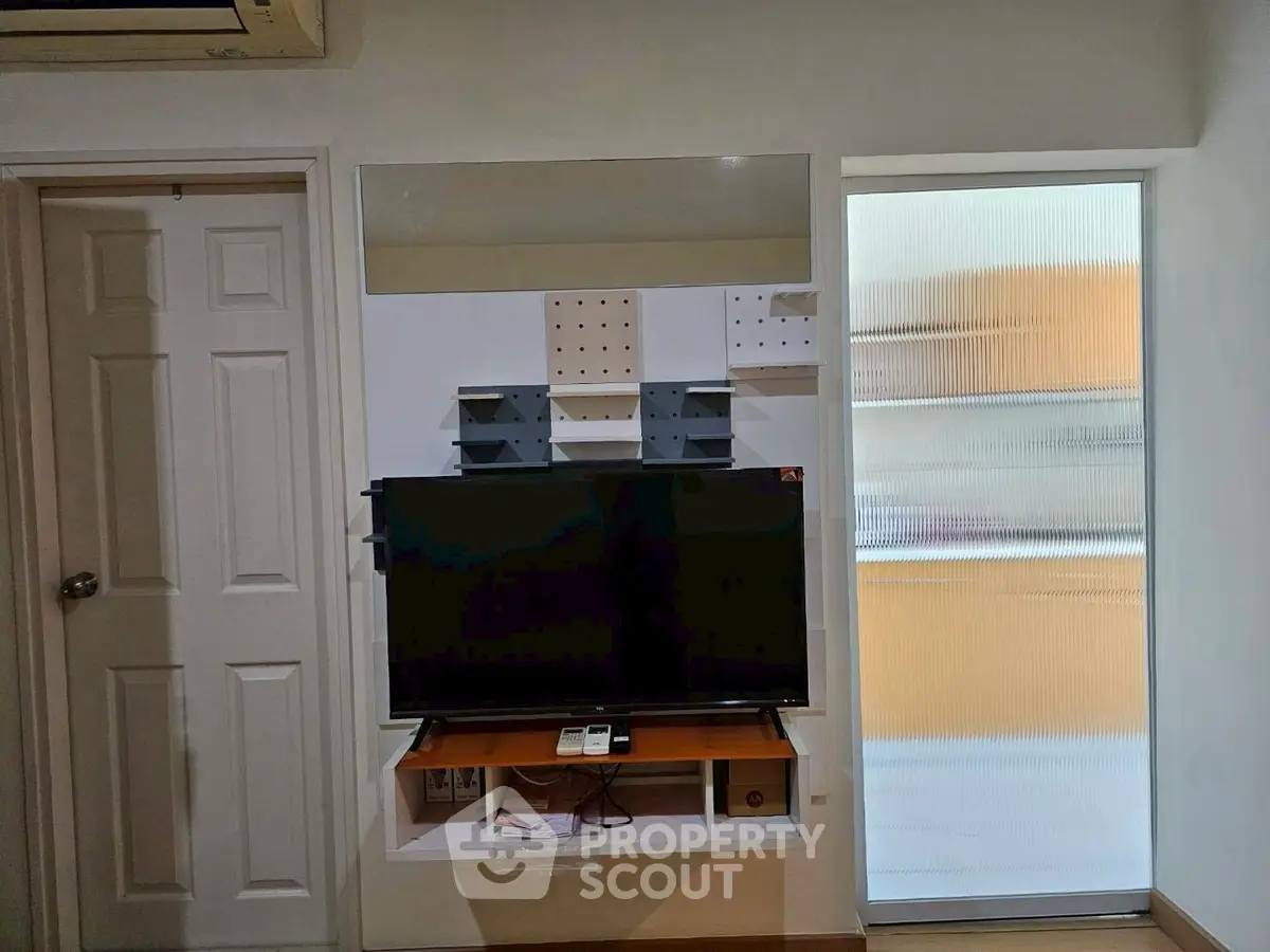 Modern living room with wall-mounted TV and sleek storage solutions