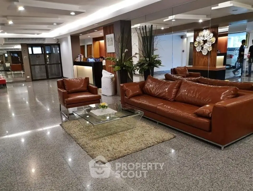 Luxurious lobby with leather sofas and modern decor in upscale building