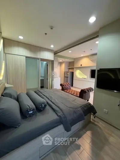 Modern bedroom with sleek design and open layout to living area