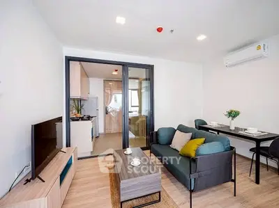 Modern living room with stylish furniture and open kitchen layout in a cozy apartment.