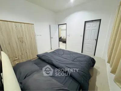 Spacious bedroom with modern decor and ample storage in a stylish home.