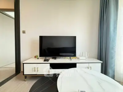 Modern living room with sleek TV setup and elegant marble table, perfect for contemporary living.