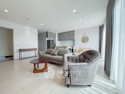 Spacious modern living room with stylish furniture and open kitchen layout