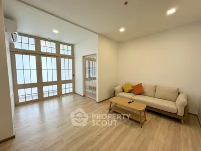 Spacious modern living room with wooden flooring and stylish furniture