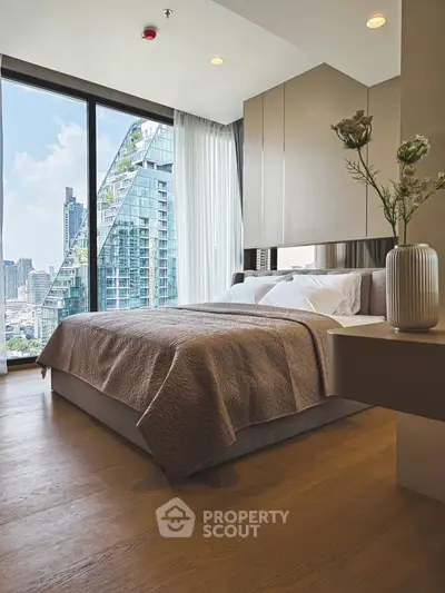Modern bedroom with city view and elegant decor in luxury apartment.