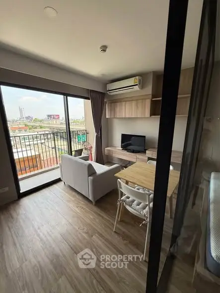 Modern living room with balcony view, featuring sleek furniture and natural light.
