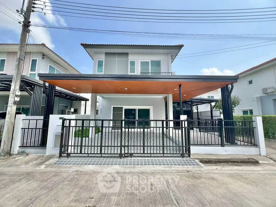 Modern two-story house with spacious driveway and sleek design