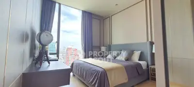 Luxurious bedroom with city view, modern decor, and elegant furnishings.
