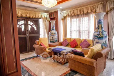 Luxurious living room with elegant decor and large vases, perfect for relaxation.