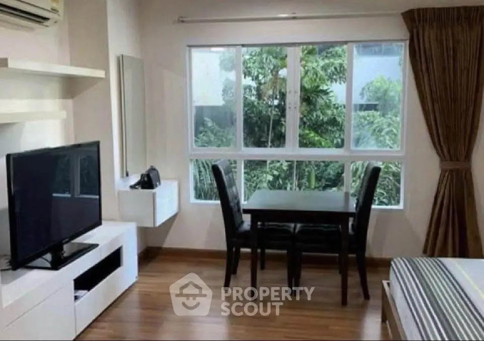 Cozy living room with large window and modern furniture