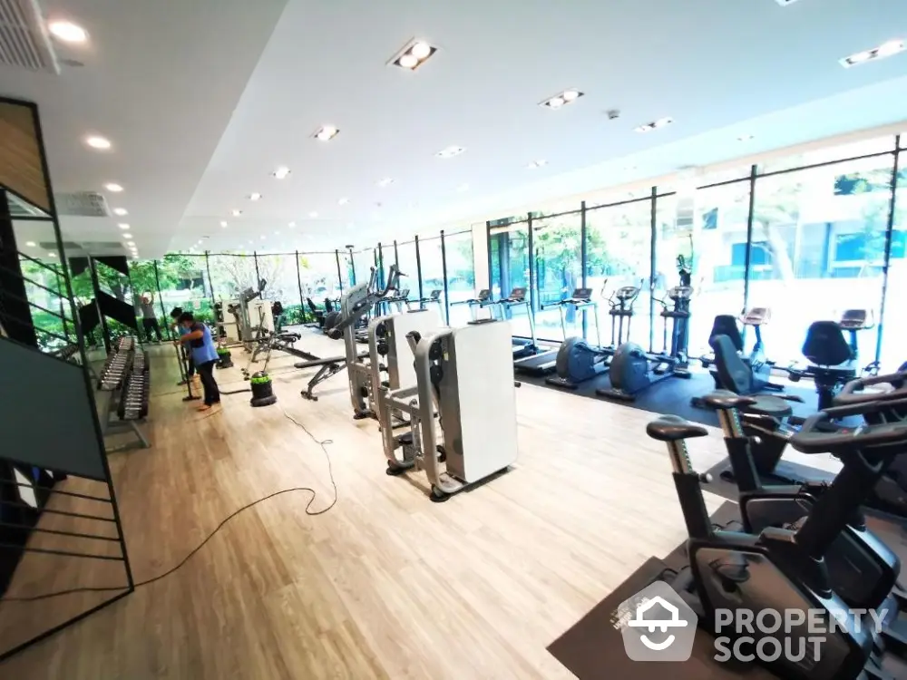 Spacious modern gym with large windows and natural light