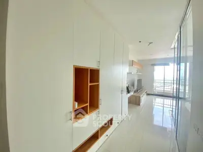 Modern apartment interior with sleek built-in storage and bright natural lighting