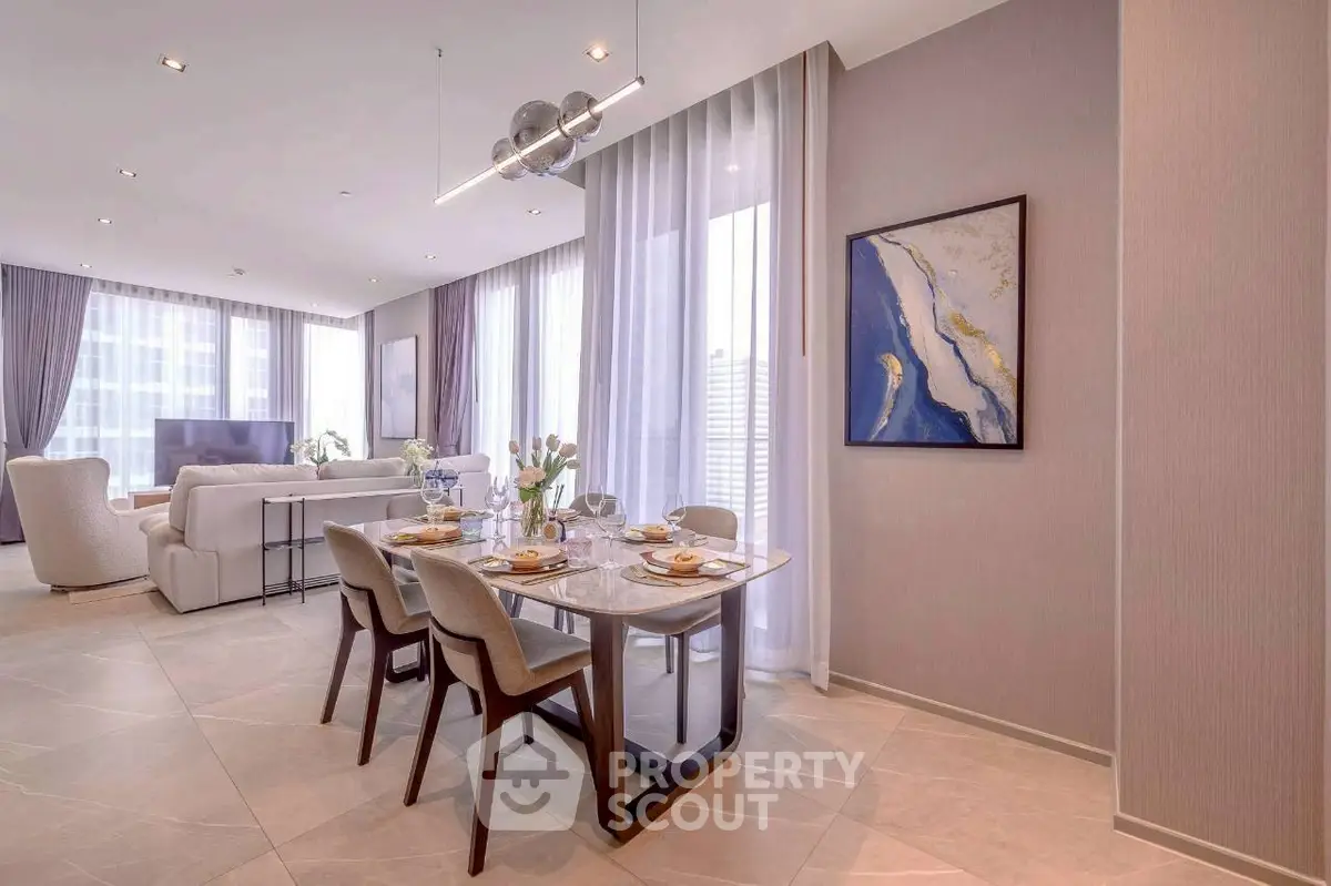 Luxurious open-plan living and dining area with elegant decor and abundant natural light.