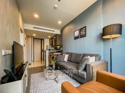 Modern living room with stylish decor and open kitchen layout in a cozy apartment.