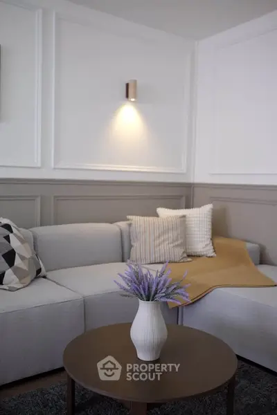 Elegant living room with modern gray sofa and stylish decor