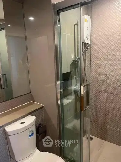 Modern bathroom with sleek shower and contemporary fixtures in a stylish apartment.