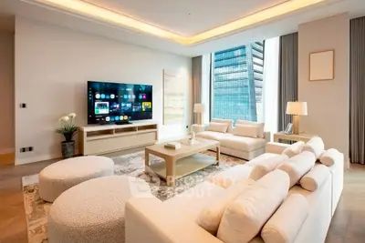 Luxurious modern living room with large windows and elegant furniture in a high-rise apartment.