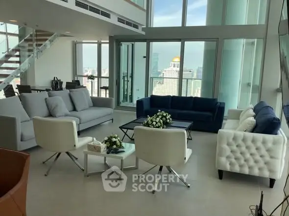 Luxurious modern living room with panoramic city views and elegant furnishings.