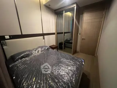 Cozy bedroom with mirrored wardrobe and modern design in a stylish apartment.