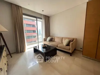 Spacious living room with modern sofa and large window offering city views.