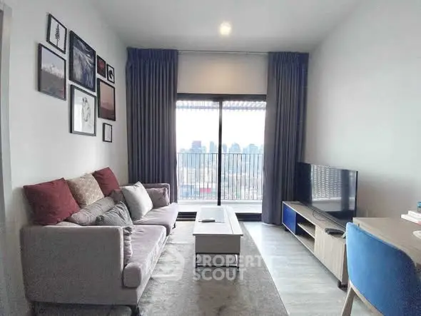 Modern living room with city view, stylish decor, and cozy seating area.